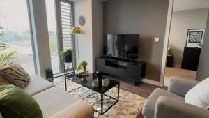 a living room with a couch and a flat screen tv at old in Manchester