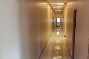 a hallway in a building with a long corridor at Hotel Radhika in Somnath