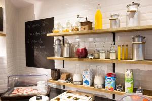 a kitchen with a chalkboard on the wall at Hotel Le Chat Noir in Paris +55 photos