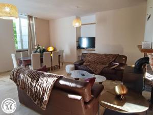 a living room with a couch and a table at La Maison de Famille in Padirac