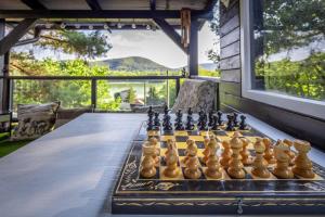a chess set on a table on a patio at Riverside Forest Apartment & Spa in Chlʼaba
