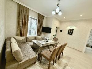 a living room with a couch and a table at Villa Gabala in Gabala