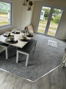a dining room with a table with plates and glasses at Billing Aquadrome holiday park - sleeps up to 7 in Great Billing