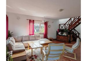 a living room with a couch and a table at Căsuța dintre Meri in Moieciu de Jos +23 photos