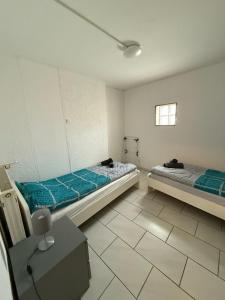 a room with two beds and a table in it at Spacious Apartment in Mörfelden-Walldorf in Mörfelden-Walldorf