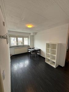an empty room with a table and chairs in it at Spacious Apartment in Mörfelden-Walldorf in Mörfelden-Walldorf