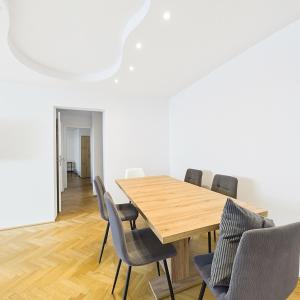 a dining room with a wooden table and chairs at Luxus Apartment in Vienna