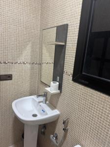 a bathroom with a sink and a mirror at Nador city corniche - Famille - in Nador +8 photos