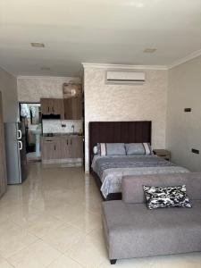 a bedroom with a bed and a couch at nador city courniche in Nador