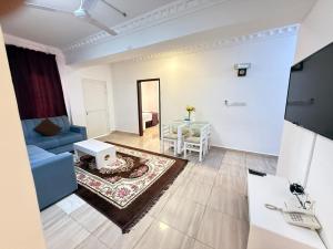 a living room with a blue couch and a table at Gateway Salalah hotel apartments in Salalah