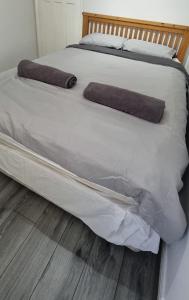 a white bed with two pillows on top of it at Tyne Relaxation in Newcastle upon Tyne +3 photos