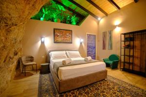 a bedroom with a bed in a cave style room at Villa Cavetta in Agrigento