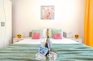 a bedroom with a bed with pink and green sheets at Stepup Apartment, Downtown Bucharest, City Center, Garden View in Bucharest