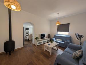 a living room with a blue couch and a table at Livingtarifa Casa Luz in Facinas