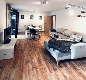 a living room with a couch and a table at TulasHomeBlue in Hamm