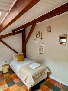 a small bedroom with a bed in a attic at Stunning Boutique gîte Flore at Vive le Vert in Bussière-Badil +42 photos