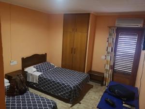 Ένα ή περισσότερα κρεβάτια σε δωμάτιο στο Nuevo Hostal Pepe