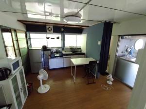 a small kitchen with a table and a counter top at たけのこ古民家いちはらキッズベース in Ichihara