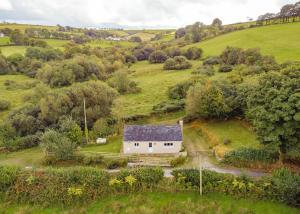 an aerial view of a white house in a field at Tranquil 1 bedroom cottage 15 mins drive to sea in Mydroilin