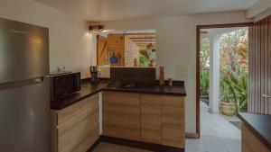 a kitchen with a refrigerator and a counter top at Beach apartment, Ti Clé de Lo in Pointe-Noire