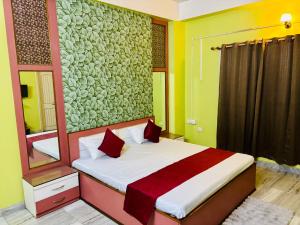 a bedroom with a bed with red pillows at Blue Vista Homestay in Guwahati +3 photos