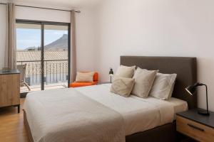 ein Schlafzimmer mit einem Bett und einem großen Fenster in der Unterkunft MarAnteMar Refuge between Sea and Tranquillity in Pontinhas