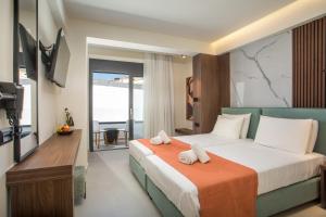 a hotel room with a bed with towels on it at Aurora Living - Adults Only in Faliraki