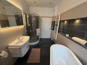 ein Badezimmer mit Waschbecken, Toilette und Badewanne in der Unterkunft City Apartment 1 in Bad Nenndorf