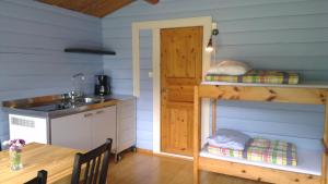 a kitchen with a table and a sink in a room at Folven Adventure Camp in Hjelle