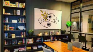 a room with a table and some bookshelves at Luxury, Comfort and Unforgettable View of Sandton in Johannesburg +54 photos