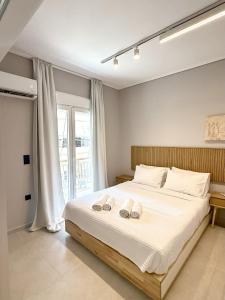 a bedroom with a bed with two towels on it at Acropolis Path - Elegant Apartment near Plaka in Athens