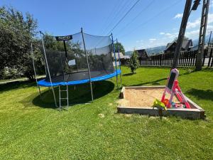a playground with a trampoline in the grass at Apartment u Heleny in Biały Dunajec
