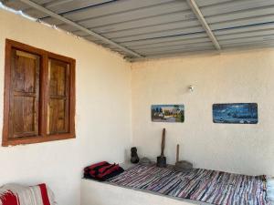 a corner of a room with a bed and a window at Mangal Srushti Agro Tourism  +11 photos