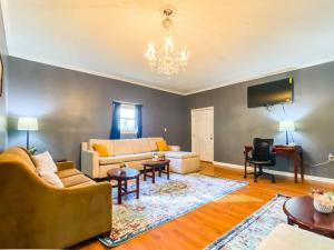 a living room with a couch and a chandelier at Cardinal Aerie in Madison