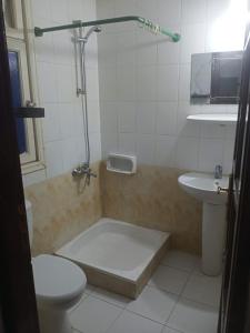 a bathroom with a shower and a toilet and a sink at Riviera Apartment in Sharm El Sheikh