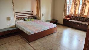 a bedroom with a large bed and a couch at vaibhav farm house in Govindgarh Malkpur