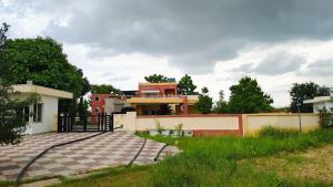 a house with a driveway in front of it at vaibhav farm house in Govindgarh Malkpur