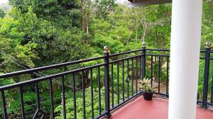 a balcony with a view of a forest at Ella Sunrise Villa in Ella
