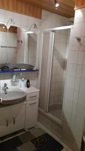a white bathroom with a shower and a sink at HomeStay Sandra in Hockenheim +16 photos