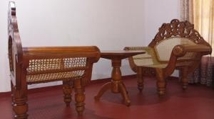two chairs and a wooden table and a table and chairs at Ella Sunrise Villa in Ella +48 photos
