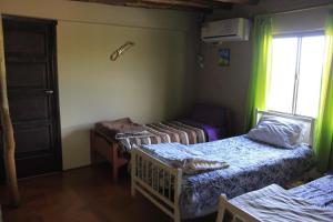 a room with two beds and a window at Manantial in Guaymallen