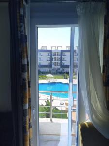 Una vista de una piscina desde una ventana. en Marsay appartmet, en Marsa Alam