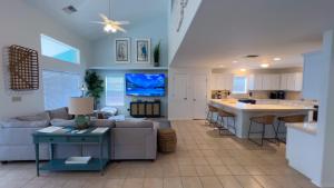 a living room and kitchen with a couch and a table at Upscale & Spacious Home - Renovated - Pool in South Padre Island