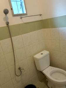a bathroom with a toilet and a shower at WJV INN Canduman in Mandaue City