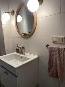 a bathroom with a white sink and a mirror at Altun's Home in Trabzon +31 photos