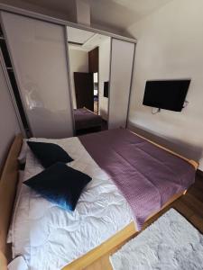a bedroom with a large bed with a mirror at Golden Pine Lux in Zlatibor +22 photos