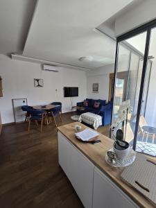 a kitchen and living room with a couch and a table at Golden Pine Lux in Zlatibor