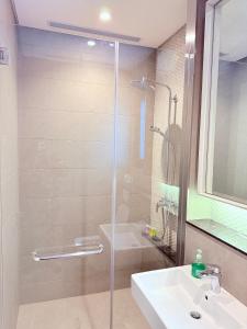 a bathroom with a shower and a sink at Lucentia Suites Bukit Bintang Kuala Lumpur in Kuala Lumpur