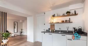 a kitchen with white cabinets and a counter top at De Jordaan Luxury in Amsterdam