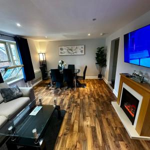 a living room with a couch and a fireplace at Two Bedroom Flat Town Centre Colchester in Colchester